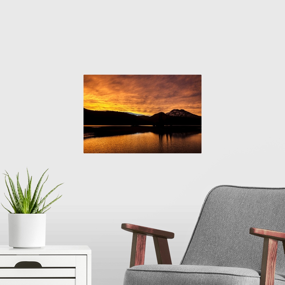 A modern room featuring View of a dramatic sunset with vibrant oranges against a silhouette of Deschutes National Forest ...