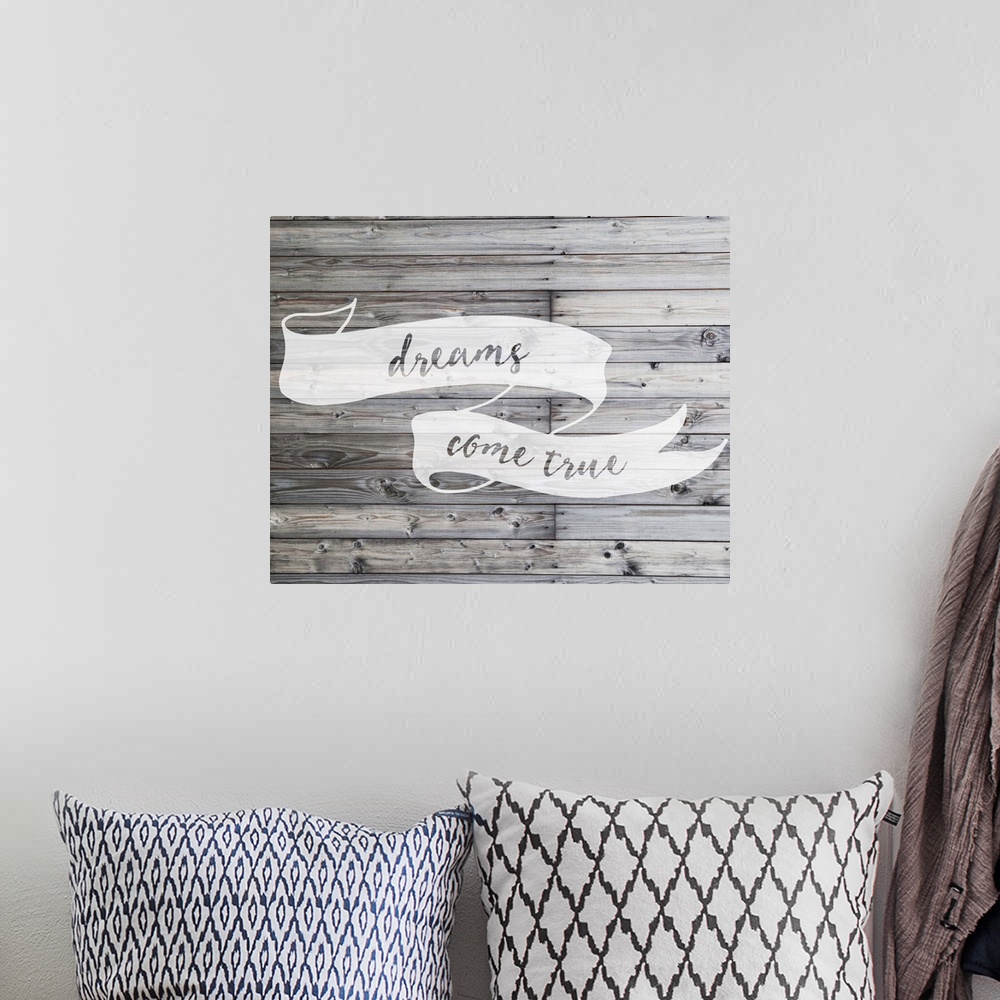 A bohemian room featuring Inspirational sentiment written on a banner, over grey wooden planks.