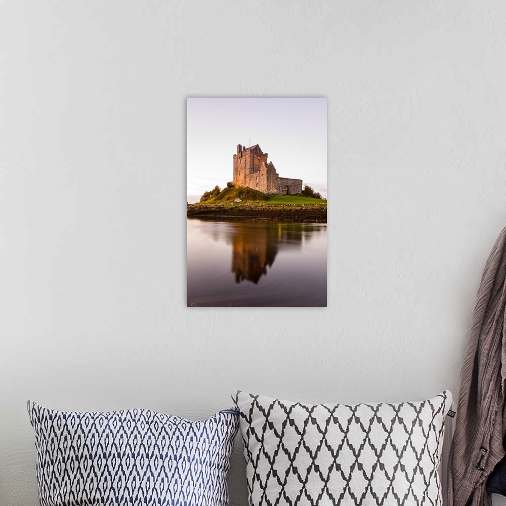 A bohemian room featuring Vertical photograph of the Dunguaire Castle reflecting into the water on the southeastern shore o...