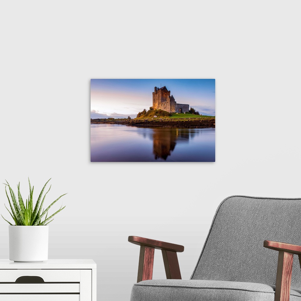 A modern room featuring Landscape photograph of the Dunguaire Castle reflecting into the water on the southeastern shore ...