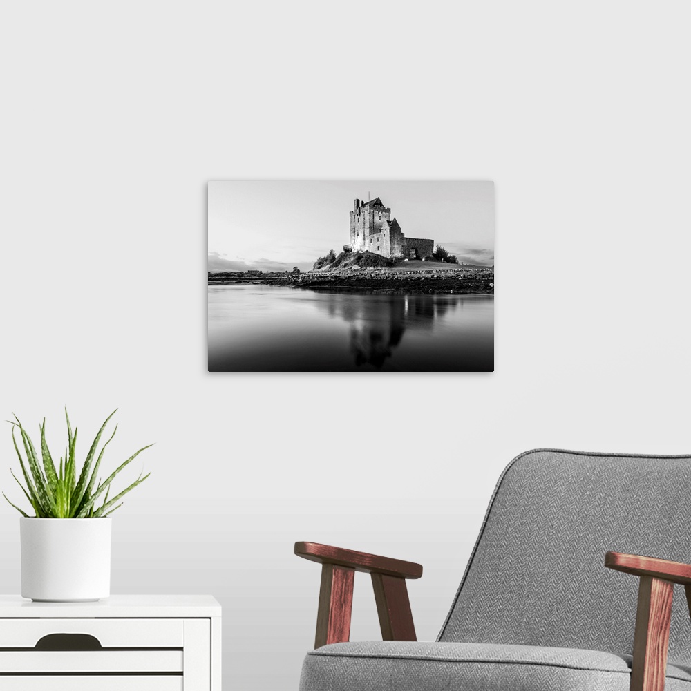A modern room featuring Black and White landscape photograph of the Dunguaire Castle reflecting into the water on the sou...