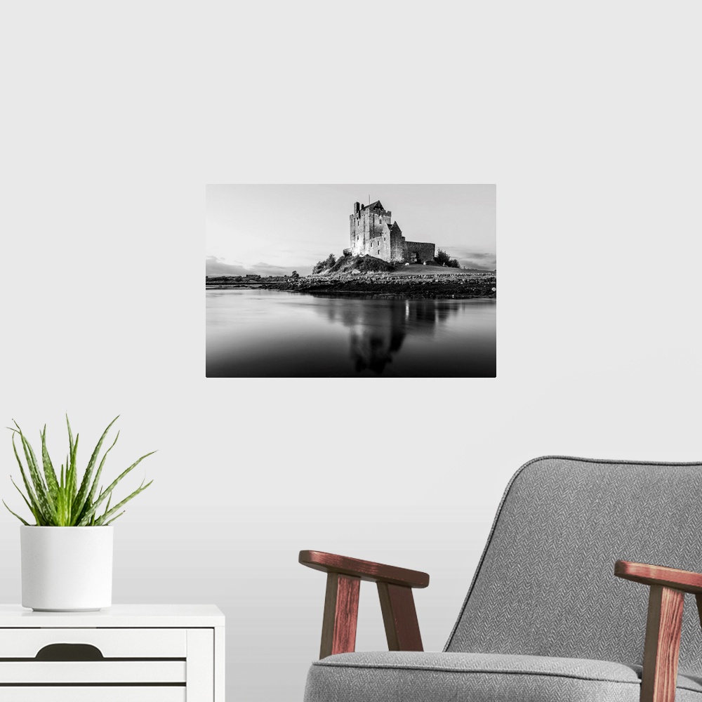 A modern room featuring Black and White landscape photograph of the Dunguaire Castle reflecting into the water on the sou...