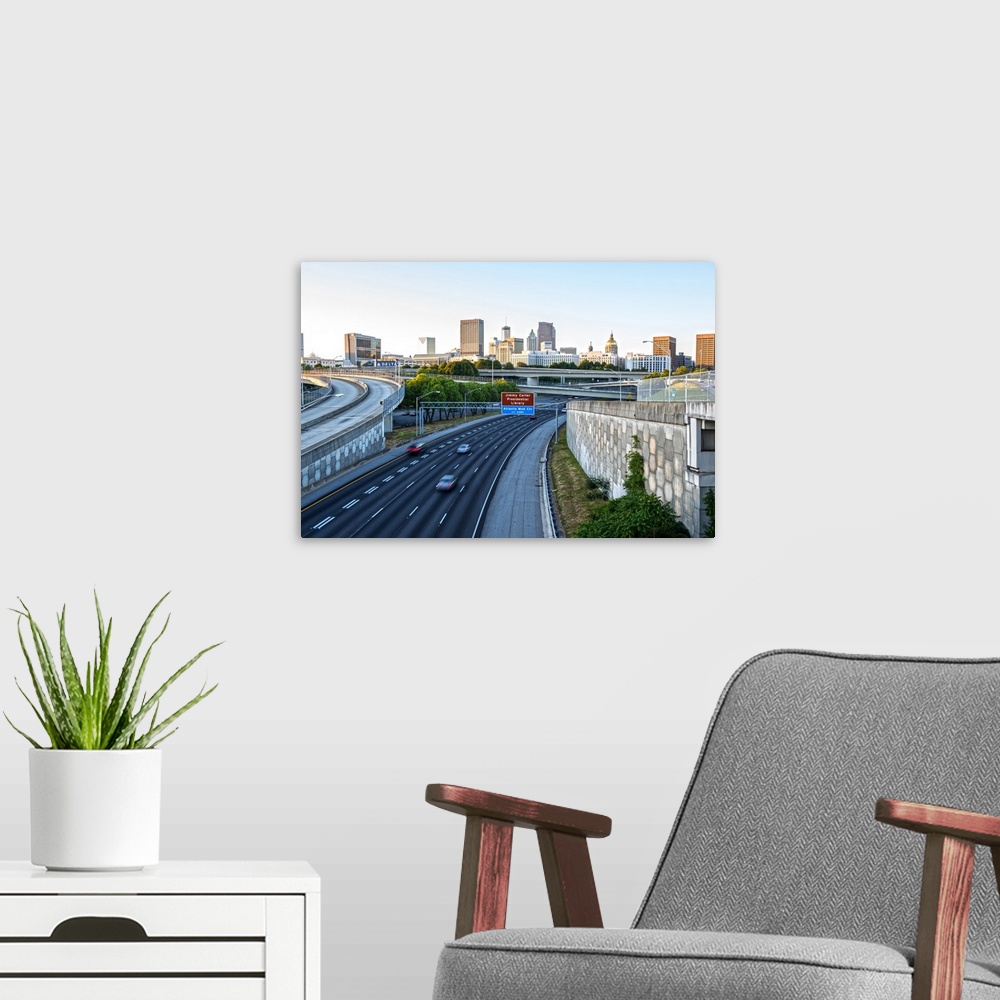 A modern room featuring Nearly empty freeway with the Atlanta, Georgia skyline in the distance, in the early morning.