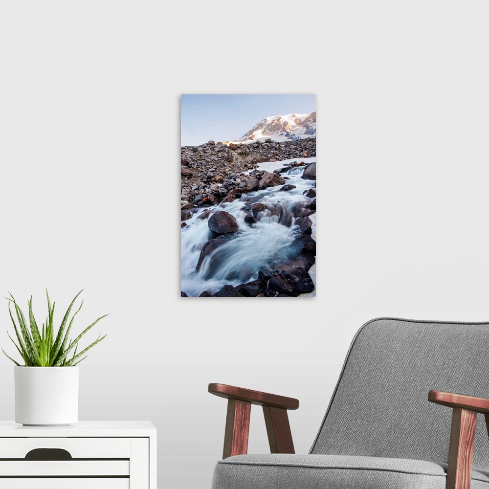 A modern room featuring Edith creek cascades down onto rocky terrain in Mount Rainier National Park, Washington.