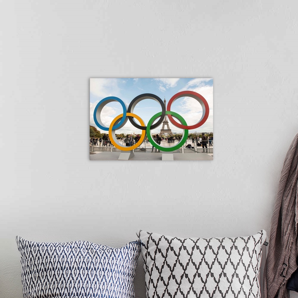 A bohemian room featuring Photograph of the Olympic Rings with the Eiffel Tower in the background.
