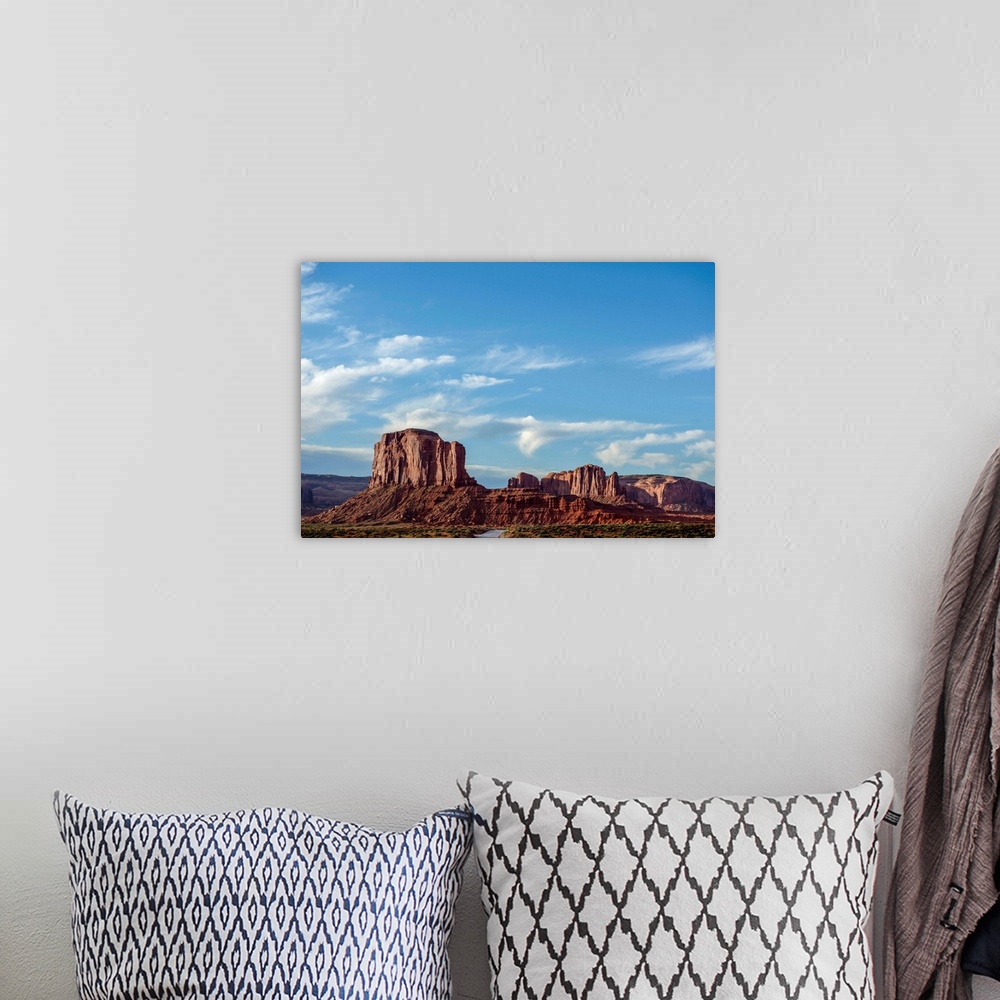 A bohemian room featuring Blue skies hover over Elephant Butte in Monument Valley, Arizona.