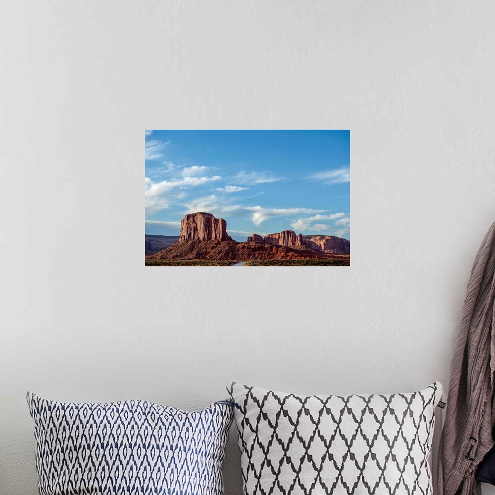 A bohemian room featuring Blue skies hover over Elephant Butte in Monument Valley, Arizona.