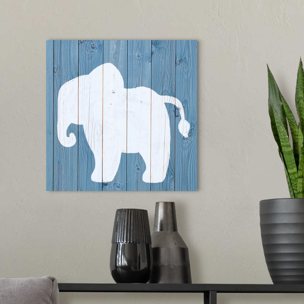 A modern room featuring Nursery art of an elephant outline painted on a blue board background.