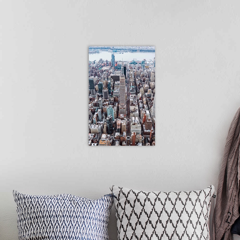 A bohemian room featuring Aerial view of the Empire State Building surrounded by skyscrapers in New York City.