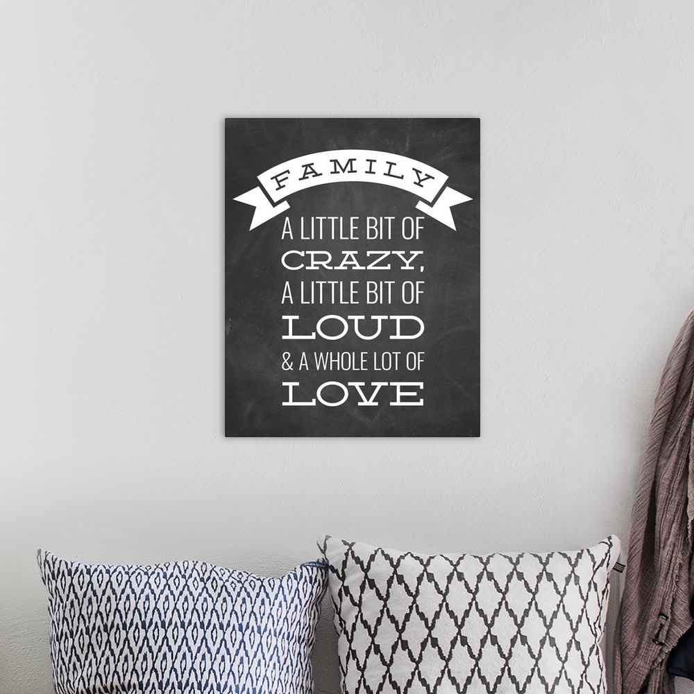 A bohemian room featuring A fun family saying in white text on a black chalkboard background.