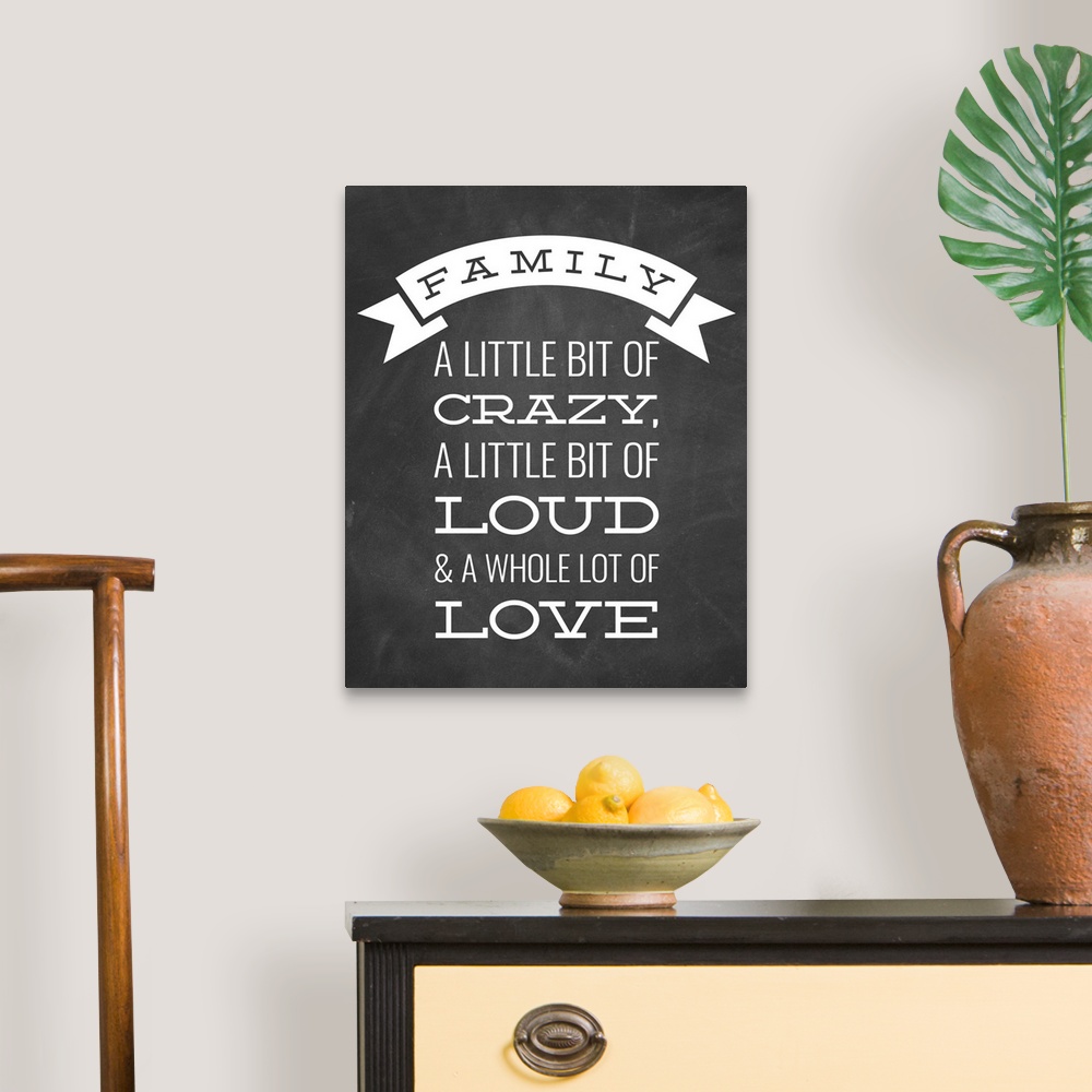 A traditional room featuring A fun family saying in white text on a black chalkboard background.