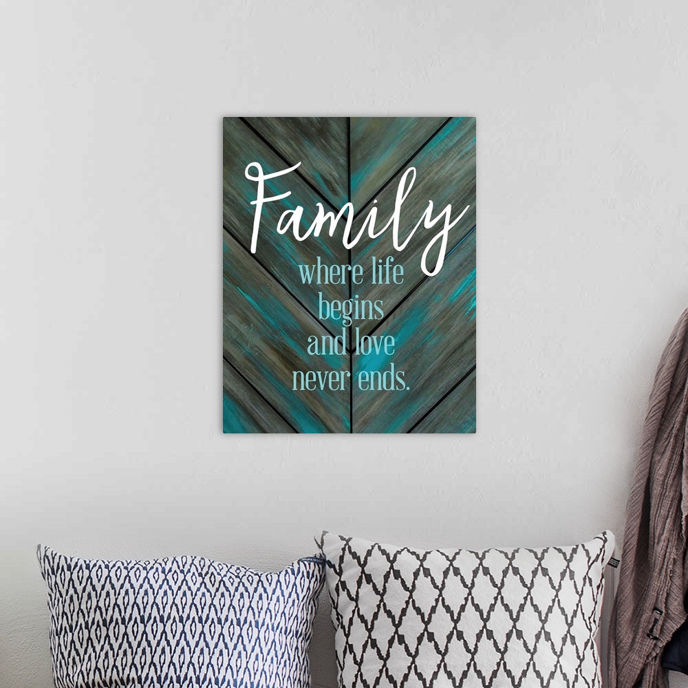 A bohemian room featuring A simple quote celebrating family on a teal and grey chevron patterned background.