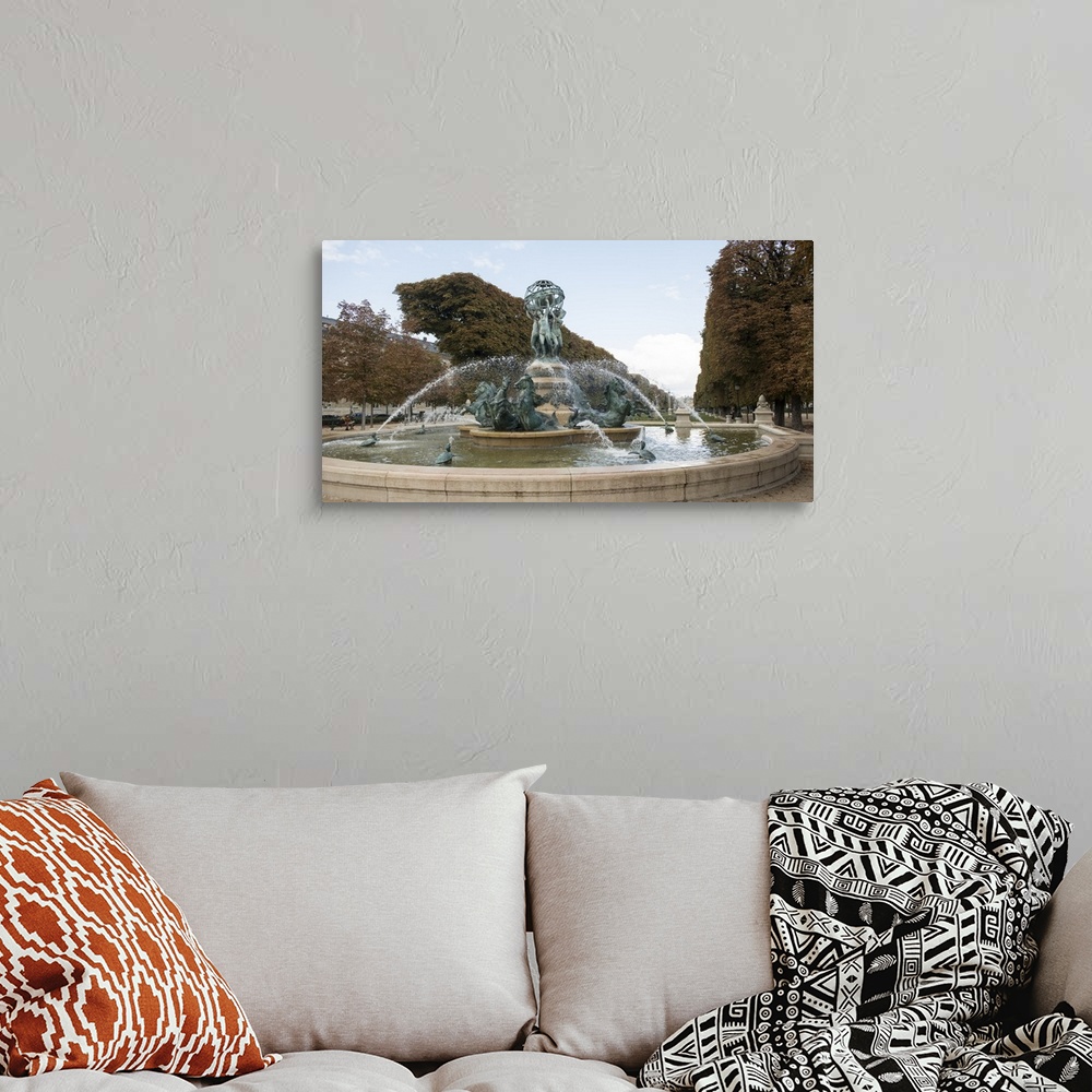 A bohemian room featuring Photograph of the Fountain Of The Observatory in Paris, France.