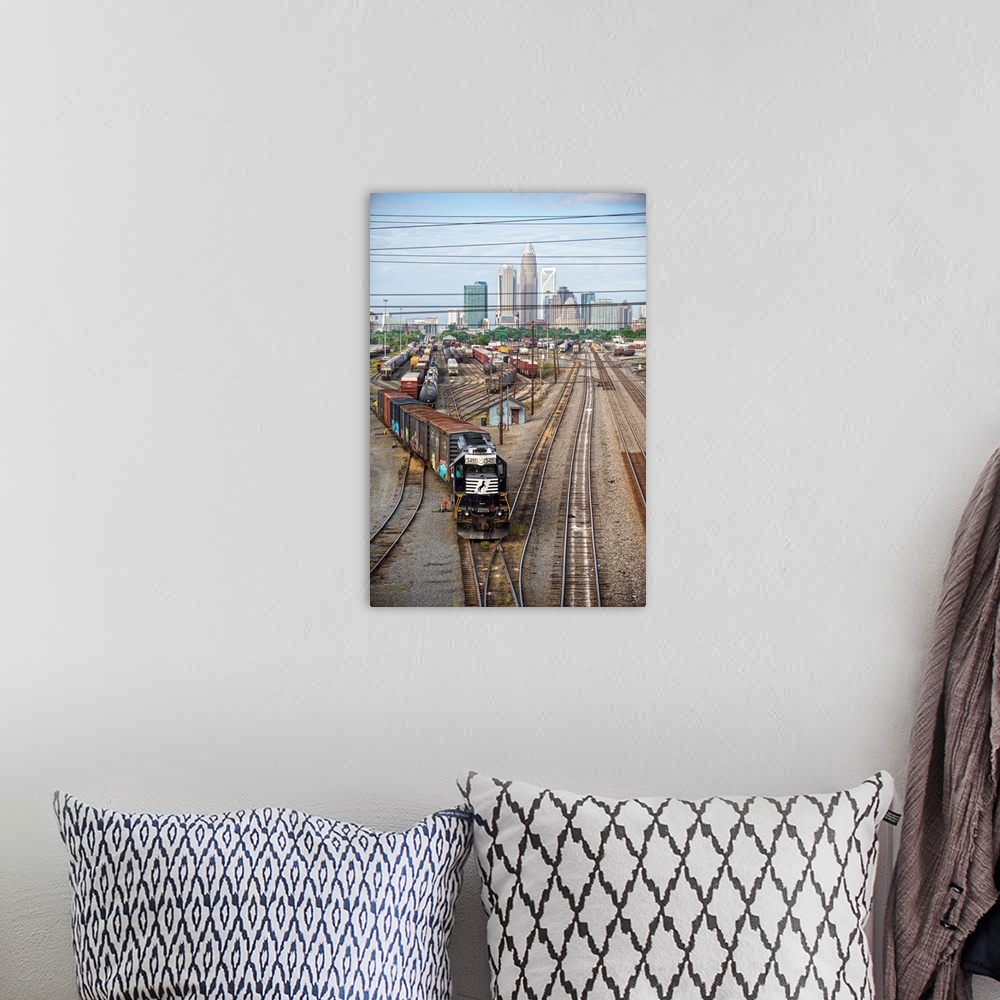 A bohemian room featuring A freight train leaving the city of Charlotte, North Carolina.