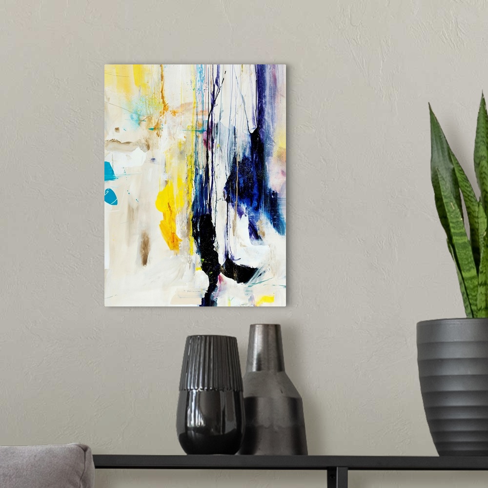 A modern room featuring Abstract painting of multicolored patches and shapes that appear to be dripping downward from the...