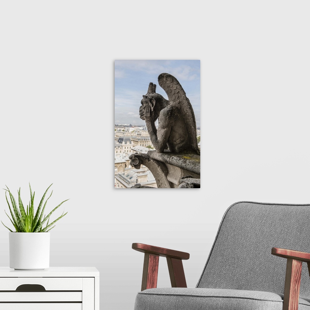 A modern room featuring Close-up photograph of a gargoyle looking over Paris.