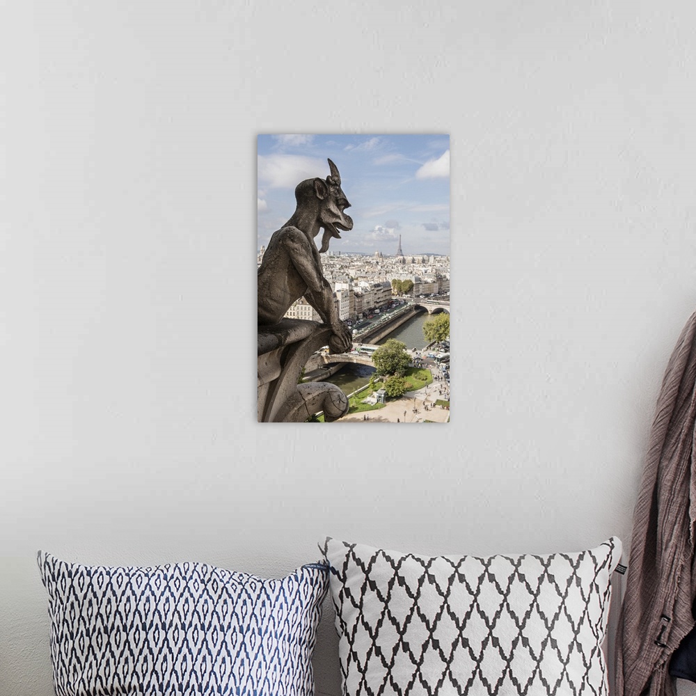 A bohemian room featuring Close-up photograph of a gargoyle looking over Paris.