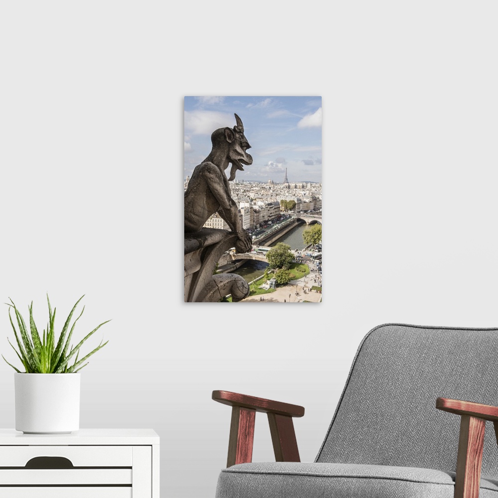 A modern room featuring Close-up photograph of a gargoyle looking over Paris.