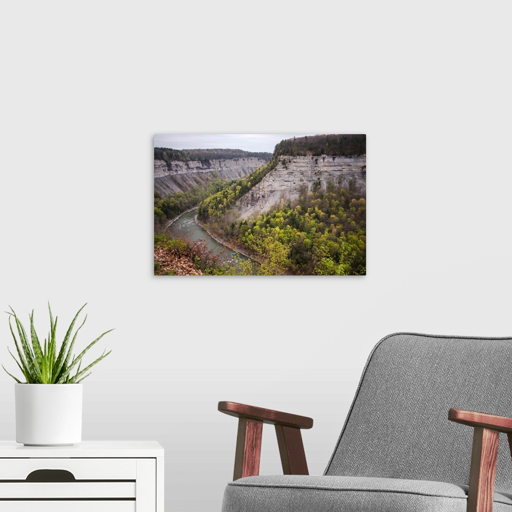 A modern room featuring Landscape photograph of the Genesee River bending around large rock formations at Letchworth Stat...