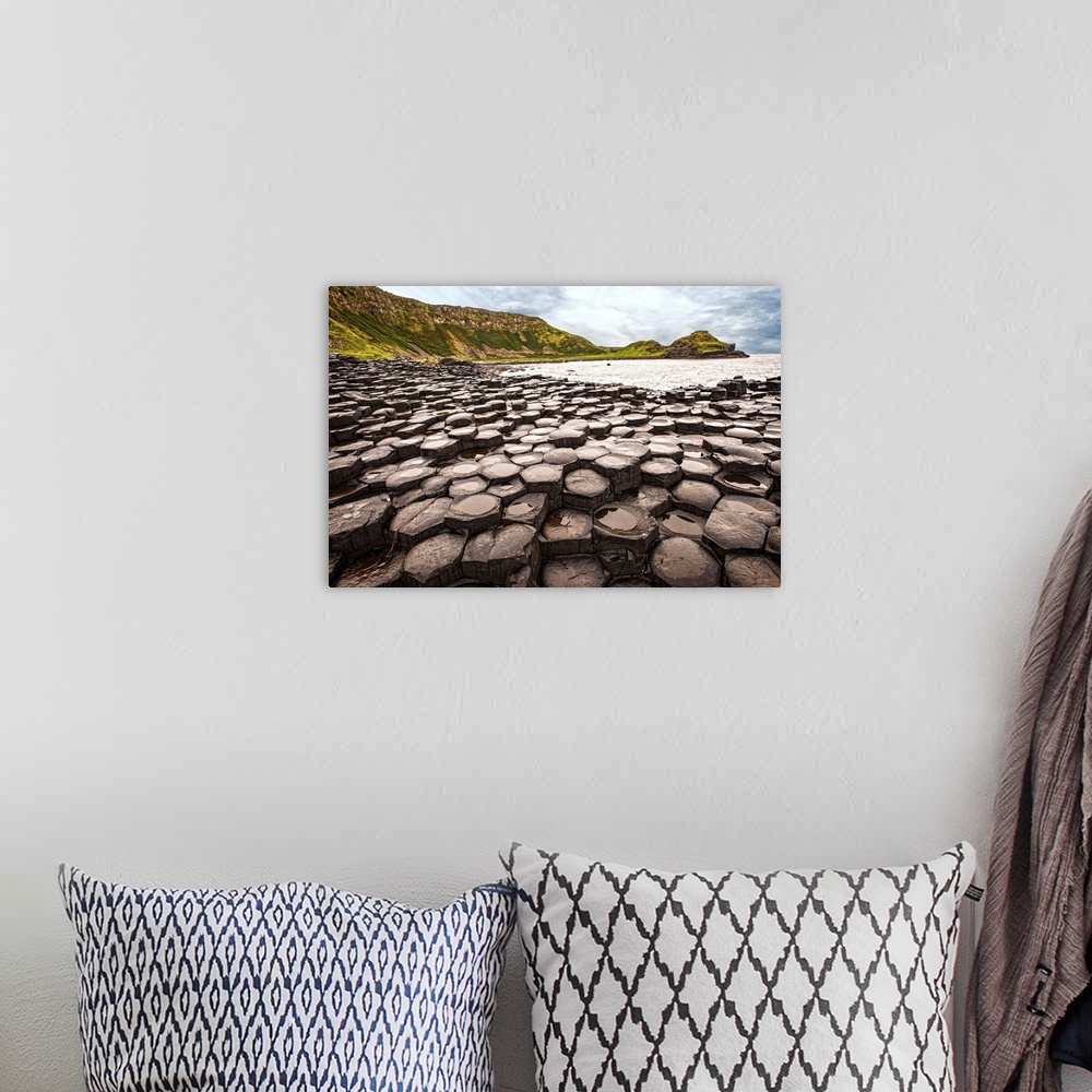 A bohemian room featuring Landscape photograph of the basalt columns on Giant's Causeway with rocky cliffs and the Atlantic...