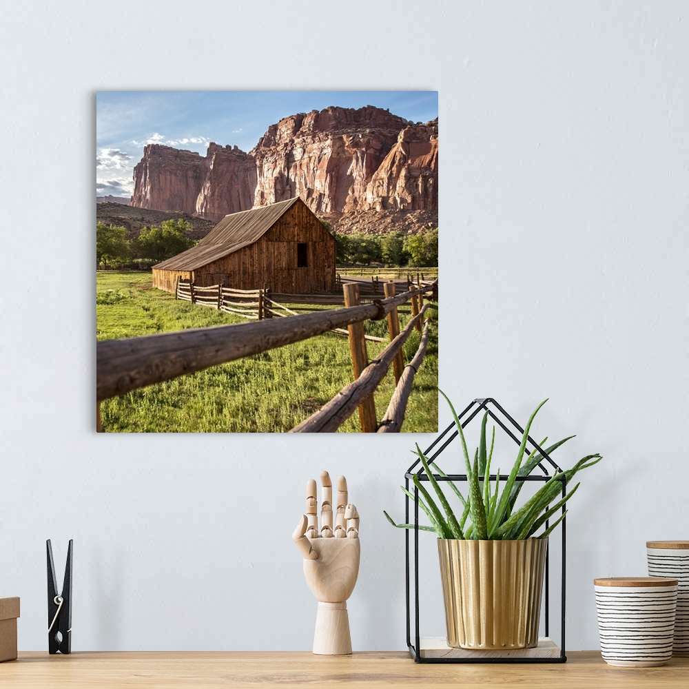 A bohemian room featuring Gifford Homestead with the cliffs of the Waterpocket Fold overlooking it at Capitol Reef National...