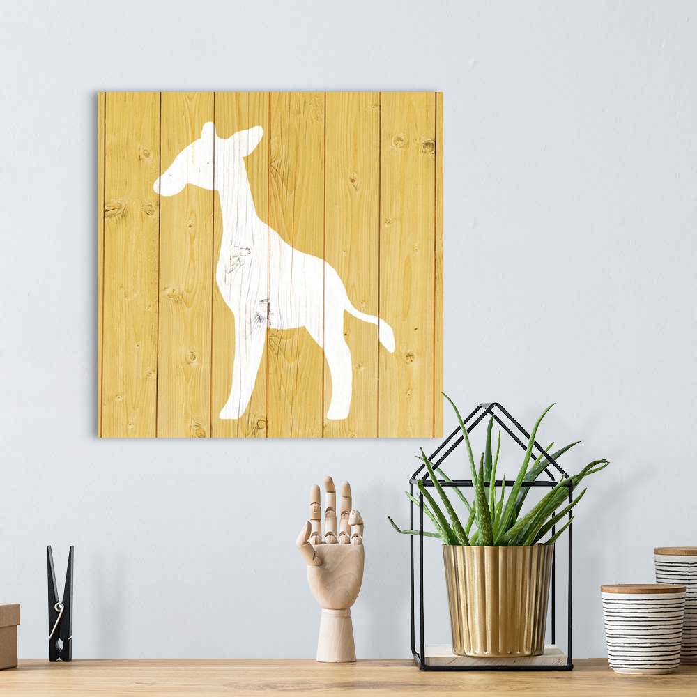 A bohemian room featuring Nursery art of a giraffe outline painted on a yellow board background.