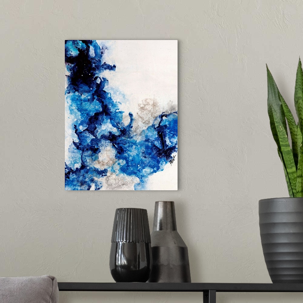 A modern room featuring Abstract painting of a mixture of varying blue tones swirling around against a neutral background.