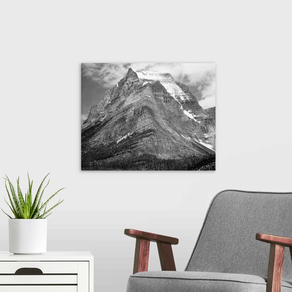 A modern room featuring Going-to-the-Sun Mountain, Glacier National Park, full view of mountain.