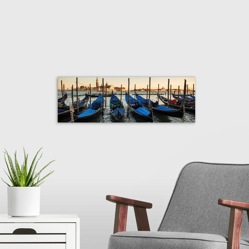 A modern room featuring Panoramic photograph of a row of docked gondolas with St. Mark's Square (Piazza San Marco) in the...
