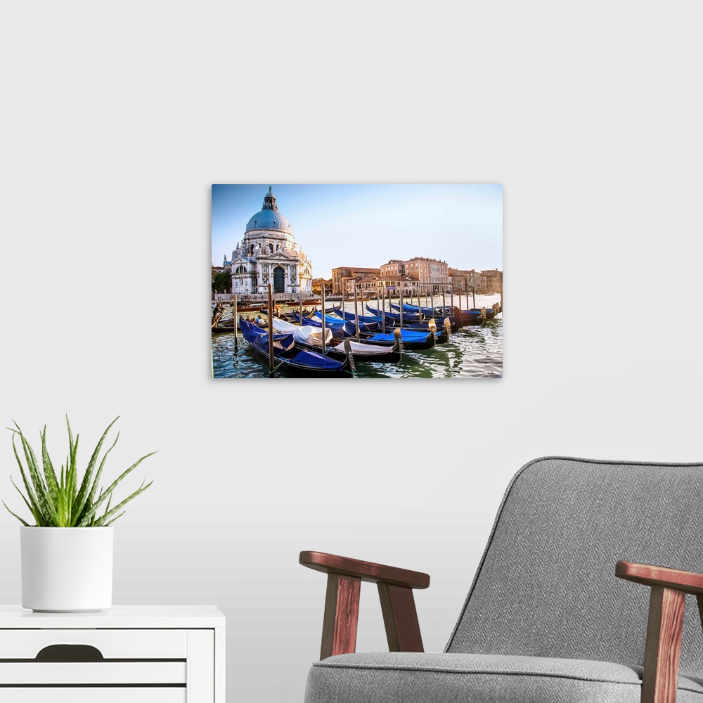 A modern room featuring Photograph of gondolas lined up in a row in front of Santa Maria della Salute, Venice, Italy, Europe