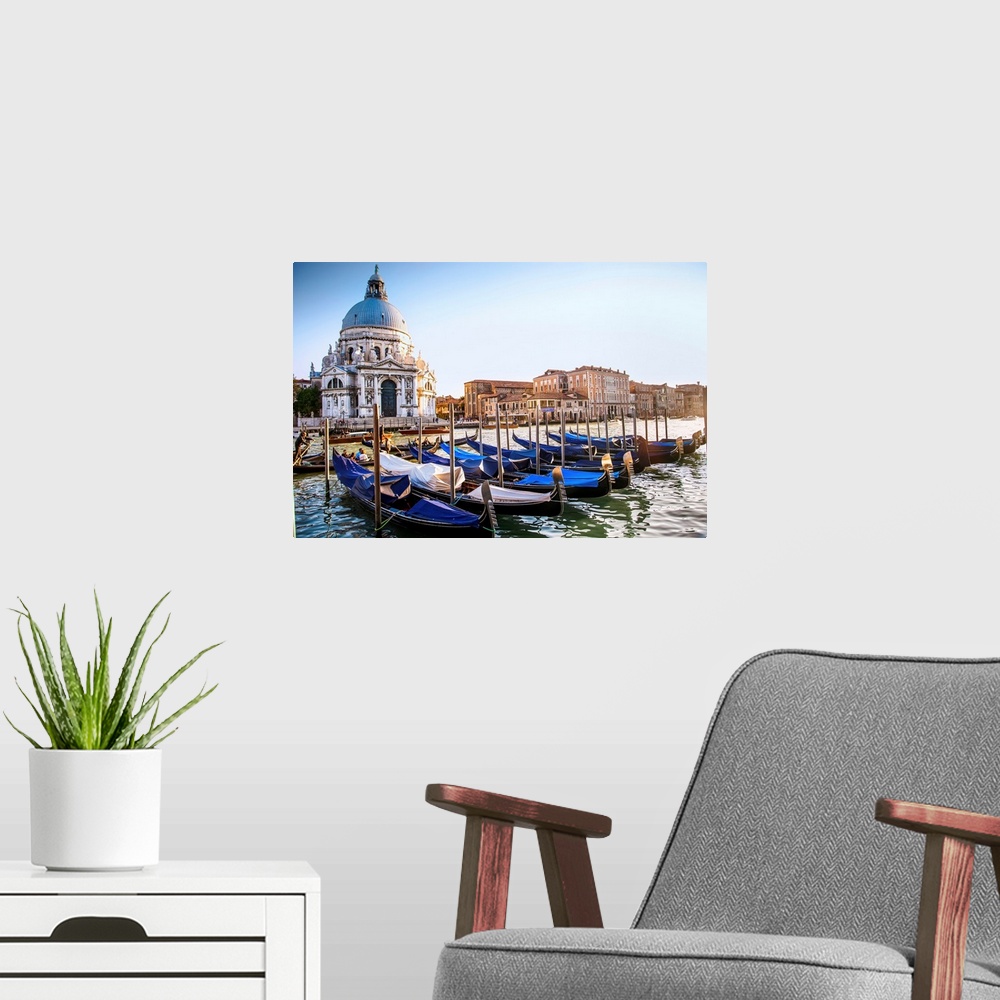 A modern room featuring Photograph of gondolas lined up in a row in front of Santa Maria della Salute, Venice, Italy, Europe