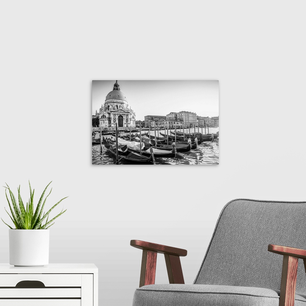 A modern room featuring Photograph of gondolas lined up in a row in front of Santa Maria della Salute, Venice, Italy, Eur...