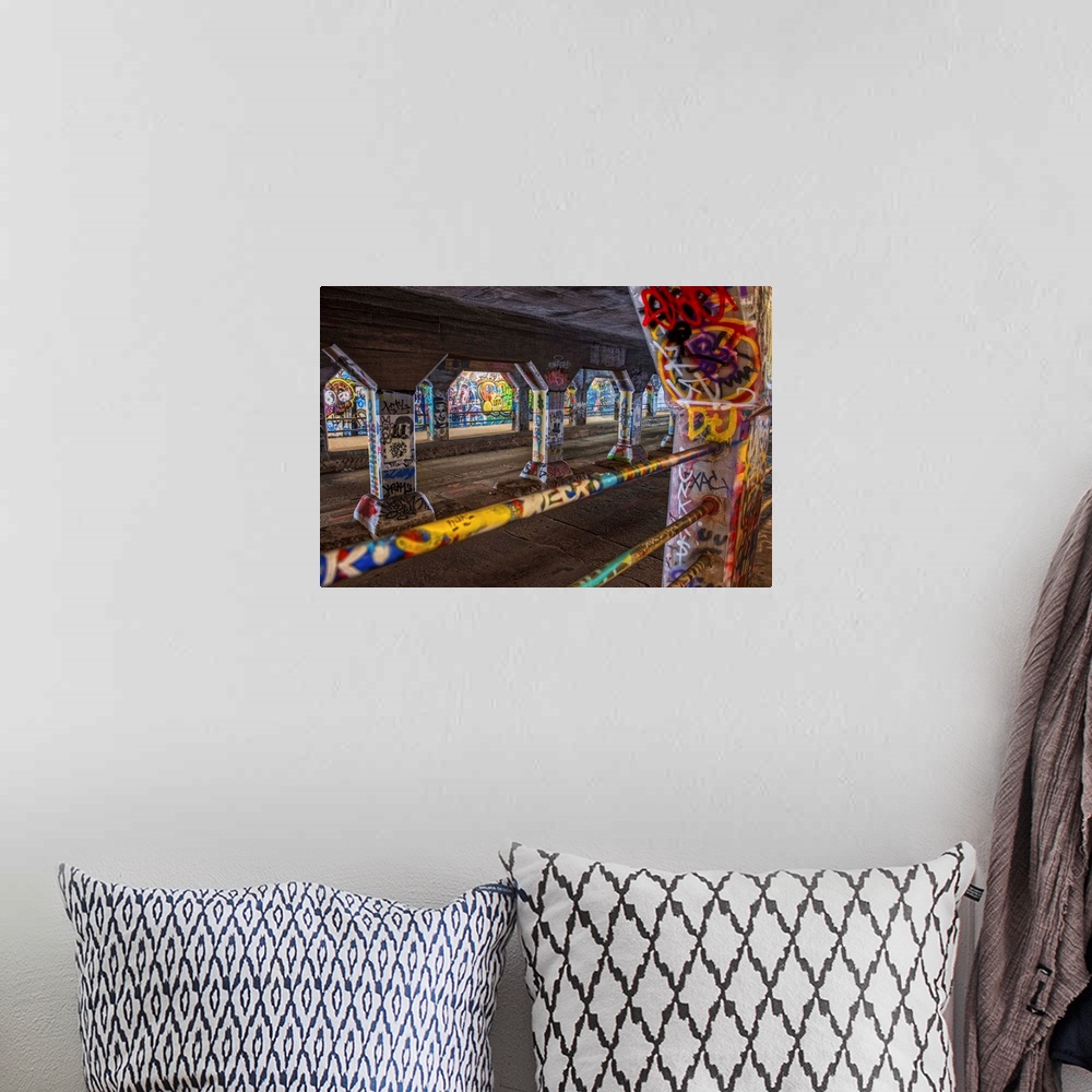 A bohemian room featuring Street art covers the walls, floors, and columns of the Krog Street Tunnel, connecting Inman Park...