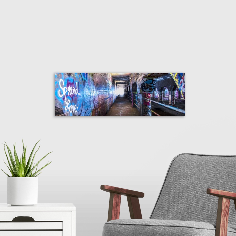 A modern room featuring Street art covers the walls, floors, and columns of the Krog Street Tunnel, connecting Inman Park...