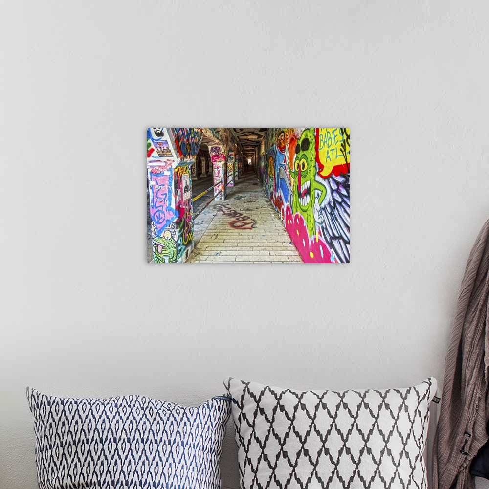 A bohemian room featuring Street art covers the walls, floors, and columns of the Krog Street Tunnel, connecting Inman Park...