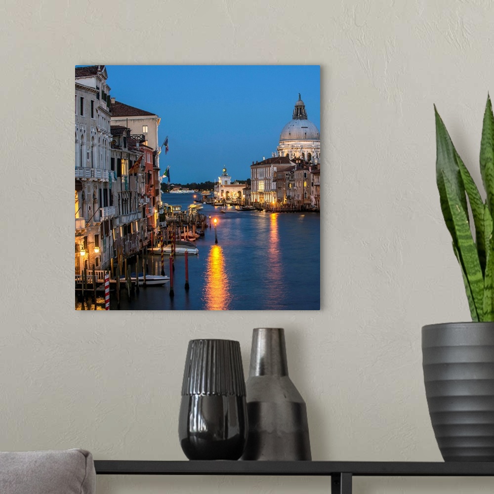 A modern room featuring Square photograph of Grand Canal lit up at night with the Santa Maria della Salute in the backgro...