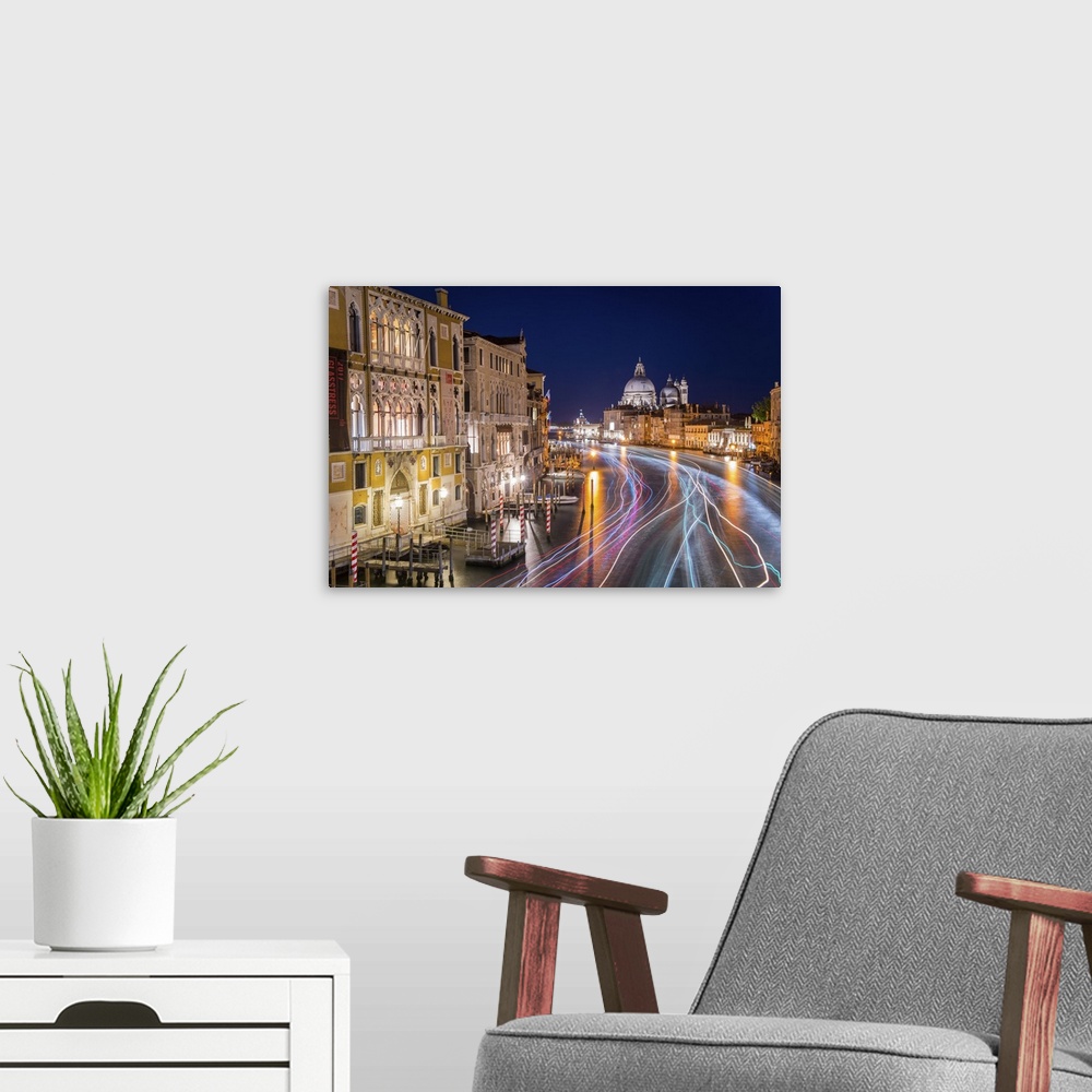 A modern room featuring Long exposure photograph of the Grand Canal in Venice lit up at night with light trails from wate...
