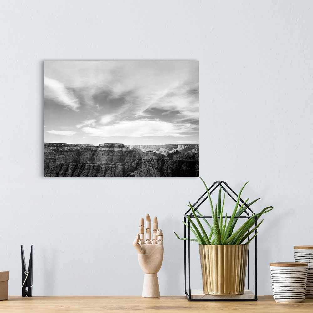 A bohemian room featuring Grand Canyon National Park, canyon edge, low horizon, clouded sky.