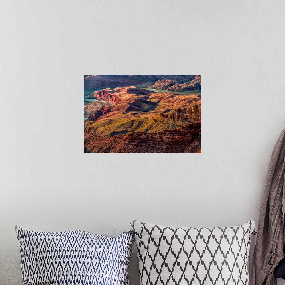 A bohemian room featuring Landscape photograph of the Colorado River winding through the Grand Canyon.
