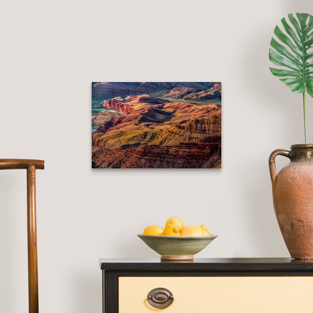 A traditional room featuring Landscape photograph of the Colorado River winding through the Grand Canyon.