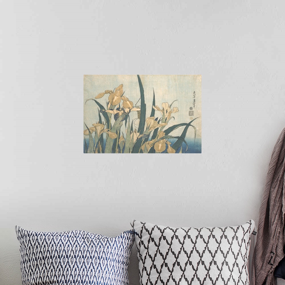 A bohemian room featuring Japanese woodblock print of a grasshopper hiding among yellow irises.