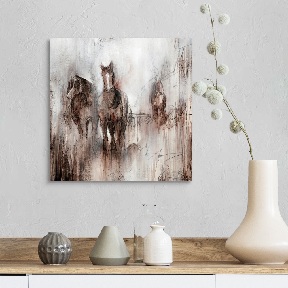 A farmhouse room featuring Artwork of three horses grazing together in a field of brown on an early foggy morning.