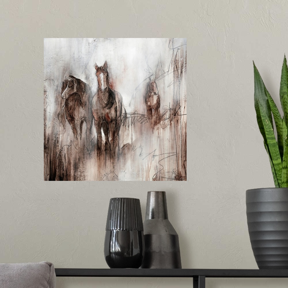A modern room featuring Artwork of three horses grazing together in a field of brown on an early foggy morning.