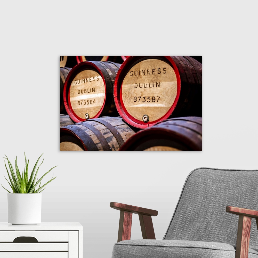 A modern room featuring Close-up photograph of Guinness beer barrels on display at the Guinness Storehouse in Dublin, Ire...