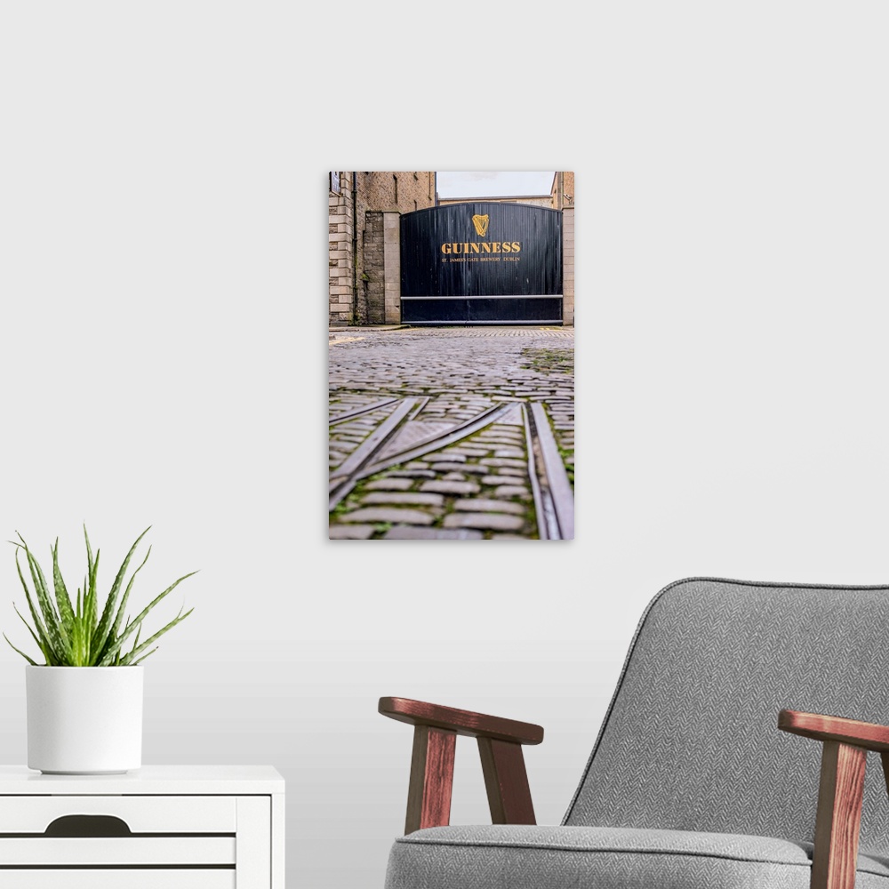 A modern room featuring Photograph of the entrance gate into the Guinness factory in Dublin.
