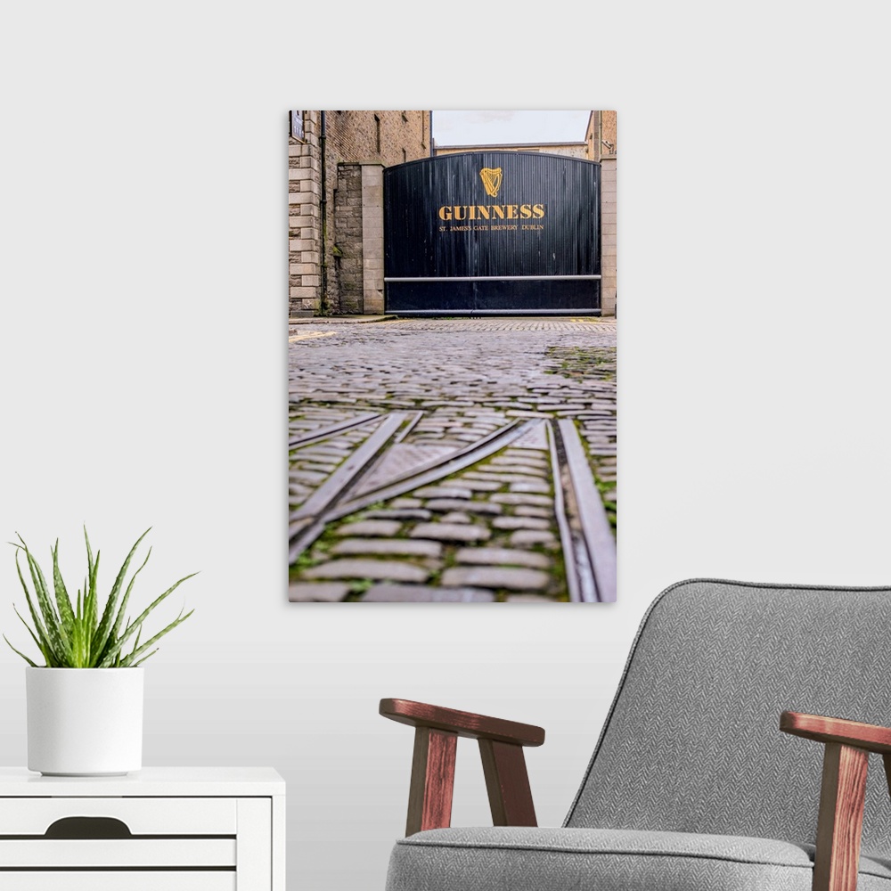 A modern room featuring Photograph of the entrance gate into the Guinness factory in Dublin.
