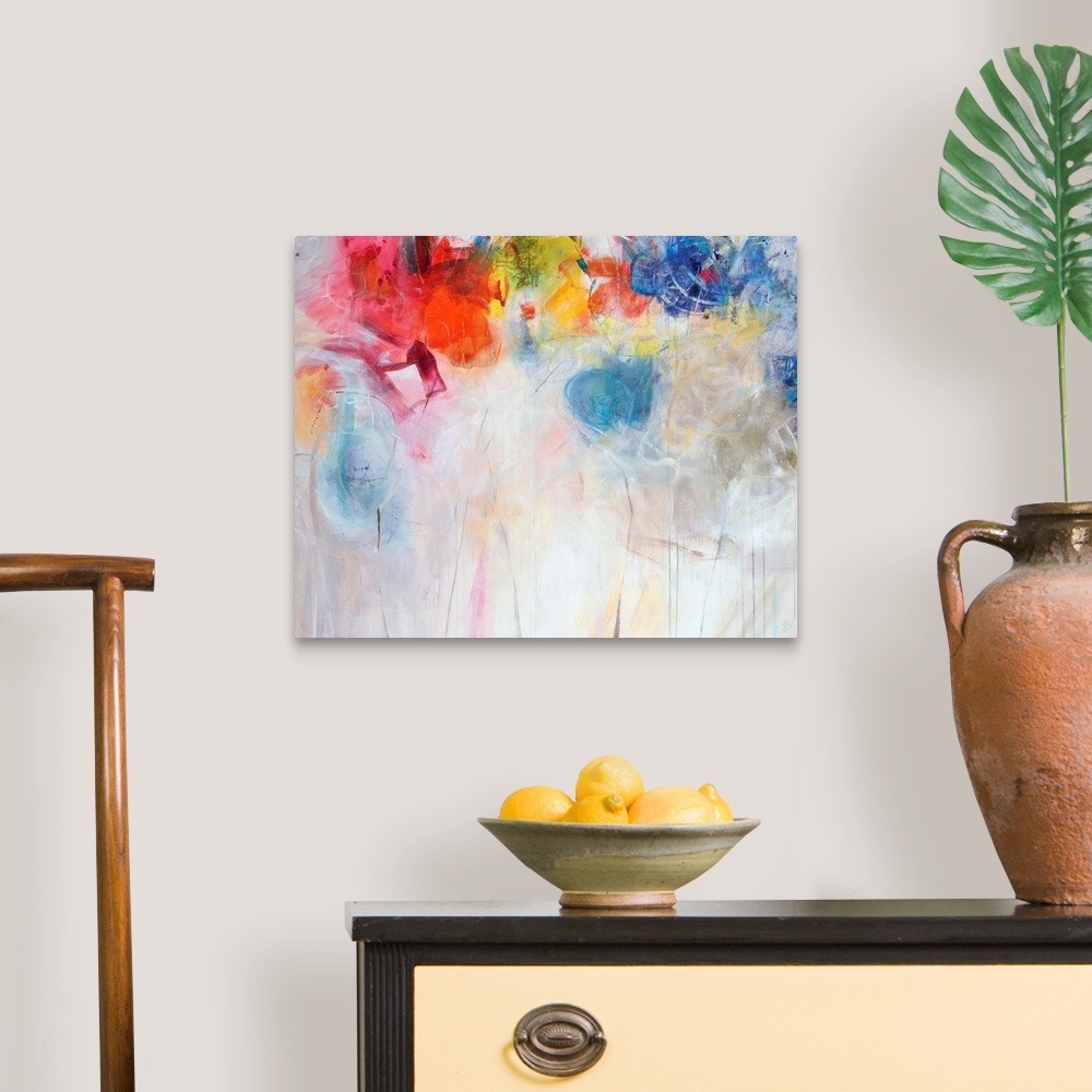 A traditional room featuring Contemporary abstract painting of bright multi-colored forms overtop a neutral background.