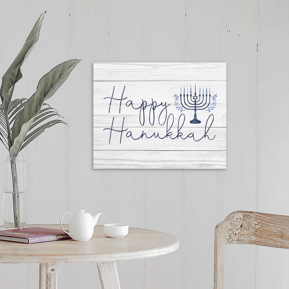 A farmhouse room featuring Happy Hanukkah in a hand-written script and blue menorah on a distressed barnwood background.