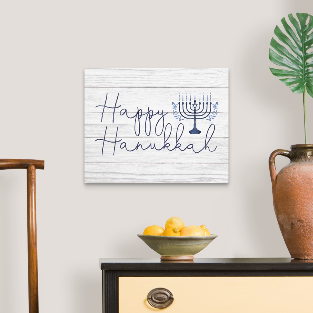 A traditional room featuring Happy Hanukkah in a hand-written script and blue menorah on a distressed barnwood background.