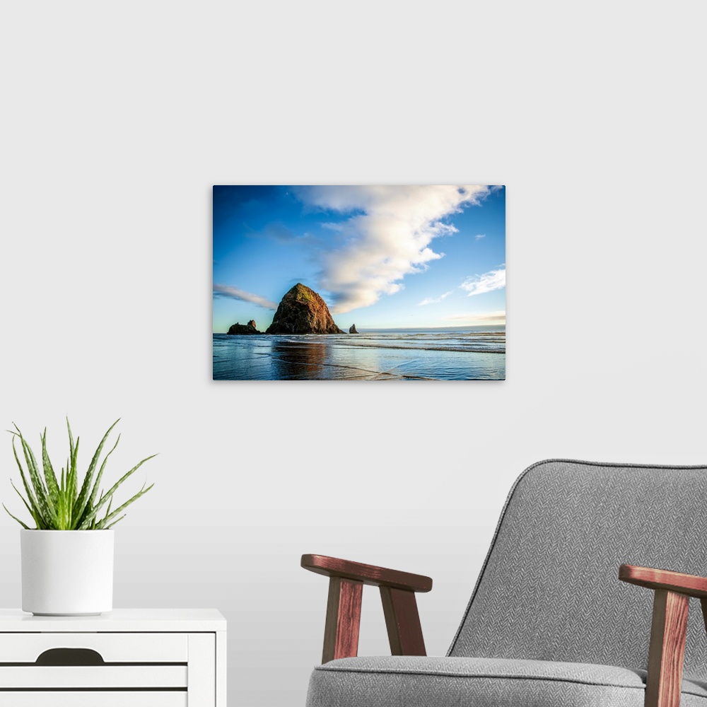 A modern room featuring Panoramic photograph of Haystack Rock at golden hour, just before sunset, Cannon Beach, Oregon.